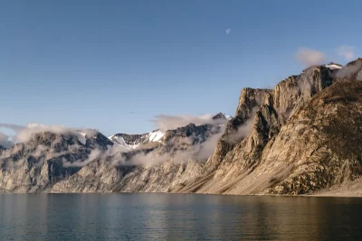 Paisagem montanhosa do Ártico com geleiras e lagoa, sob céu claro. (Foto: phys.org)