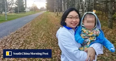 Mãe segura sua filha em um parque, com o rosto da criança protegido por pixelização, em foto publicada pelo South China Morni