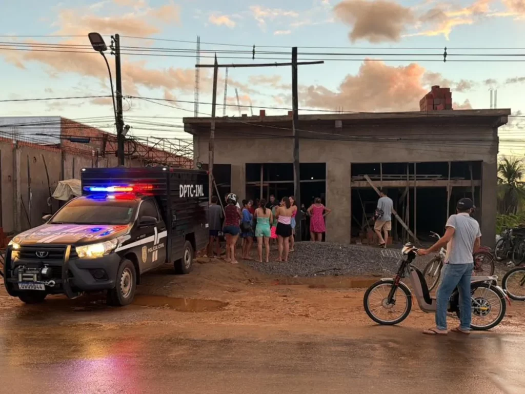 Veículo da Polícia Civil do Acre em frente a edifício com grupo de pessoas observando, em área residencial. (Foto: g1.globo.c